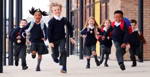 Photo of a group of children running towards the camera