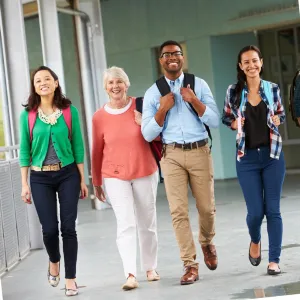 photo of a mixed group of people walking in a building